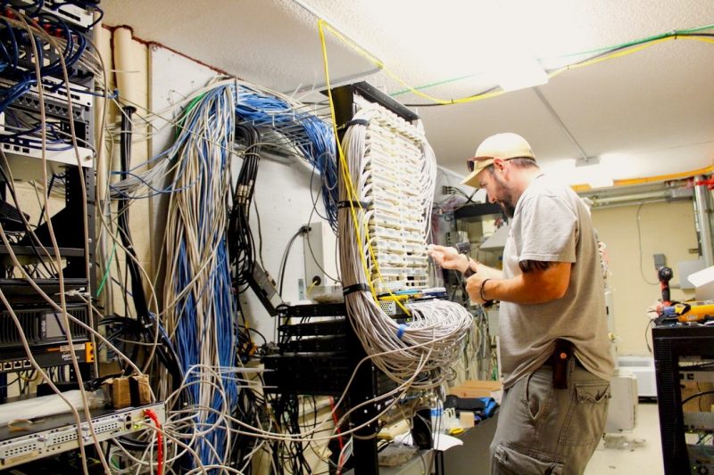 installation tech works on cables and routers