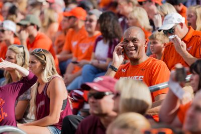 person using phone at a football game