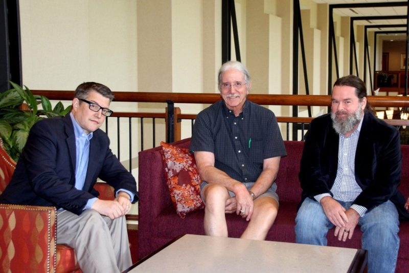 (From left) Marc DeBonis, director of Collaborative Computing Solutions; Randy Marchany, IT security officer; and Kevin Rooney, interim executive director for Secure Identity Services, seated together in a lounge area.