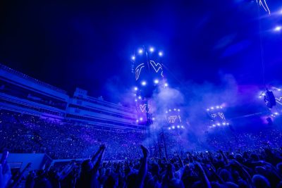 May 7, 2025 — Metallica performs a sold-out show in Virginia Tech’s Lane Stadium, with a glowing blue stage, VT logos illuminated, and a cheering crowd filling the venue.