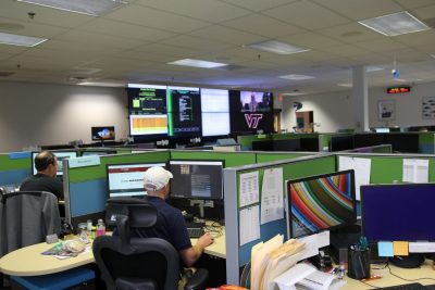 The newly upgraded 4Help operations center within RB14. Photo from 2017. The video wall allowed at-a-glance tracking of multiple servers and systems across the university, and connected with emergency responders.