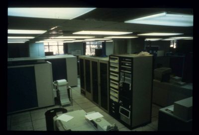 Develcon Dataswitch, center, was the primary asynchronous network on campus before Sytek LocalNet was adopted in the early 1980s. To the right is a stack of 300 to 1200 baud modems.