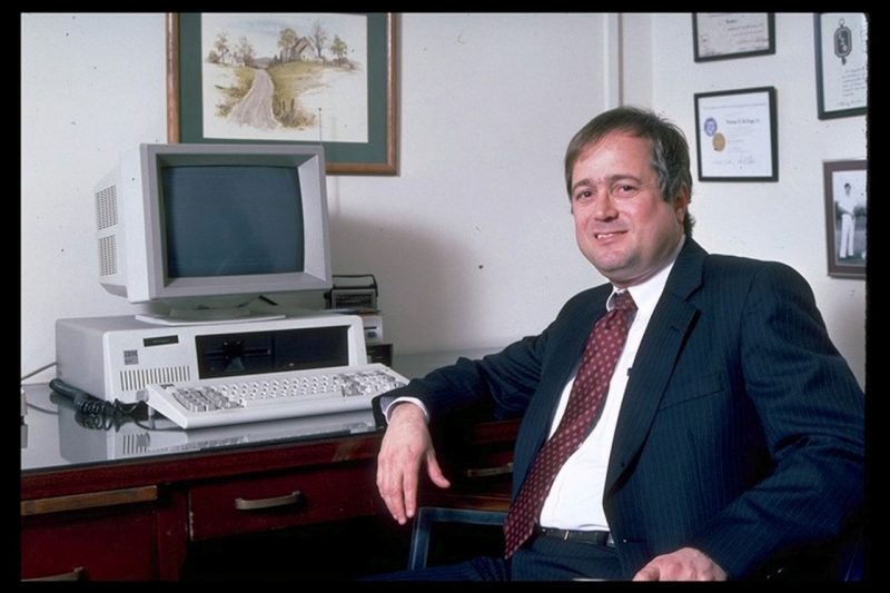 Erv Blythe, who served as VP of IT before Scott Midkiff, sits at his desk in 1989. The computer is an IBM 5151 with a newer monitor.