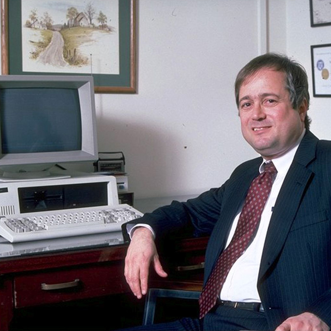 Erv Blythe, who served as VP of IT before Scott Midkiff, sits at his desk in 1989. The computer is an IBM 5151 with a newer monitor.